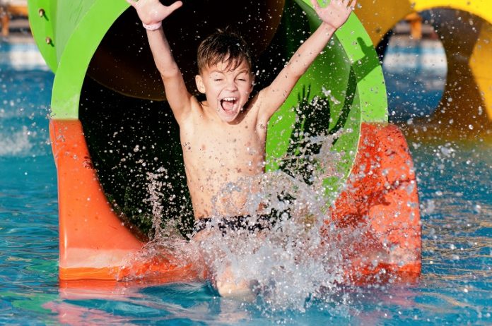 Boy,Has,Into,Pool,After,Going,Down,Water,Slide,During